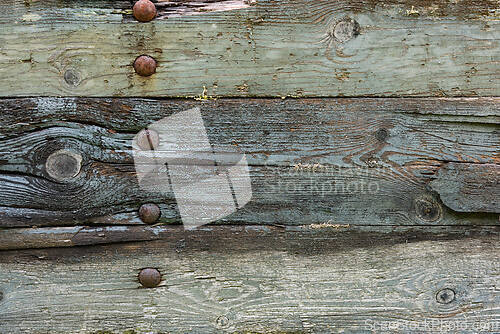 Image of Rustic wooden wall showcasing weathered texture and metal fasten