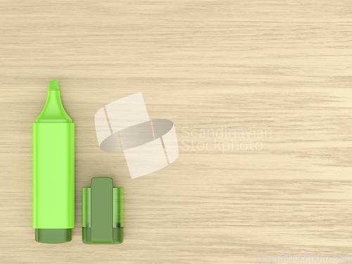 Image of Green highlighter on wooden desk