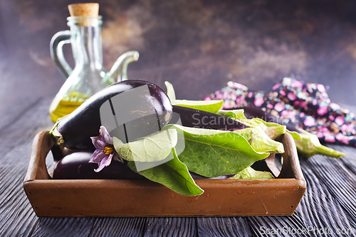 Image of Raw eggplants ( aubergines ) in wooden box. Selective focus