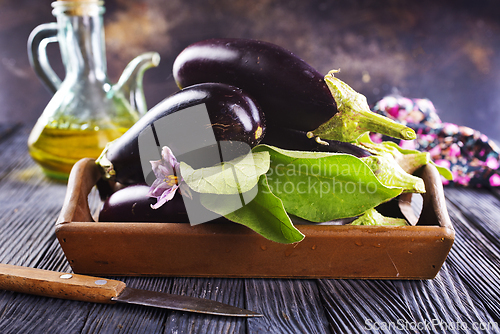 Image of Raw eggplants ( aubergines ) in wooden box. Selective focus