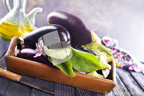 Image of Raw eggplants ( aubergines ) in wooden box. Selective focus