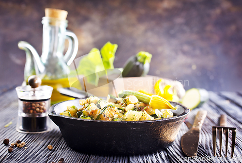 Image of Baked vegetables in pan on a table, close up view