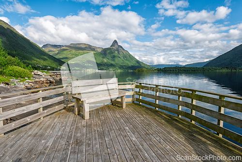 Image of Scenic viewpoint showcasing a tranquil fjord and towering mounta