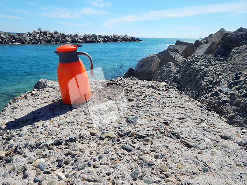 Image of Orange thermos jug.