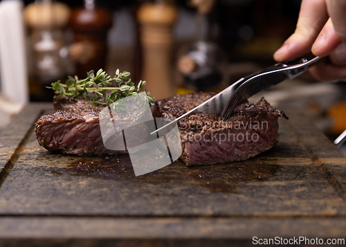 Image of Steak on cutting board, garnished with fresh thyme