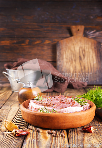 Image of raw steak with aroma spice and salt