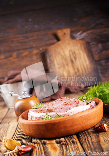 Image of raw steak with aroma spice and salt