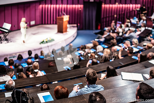 Image of Woman giving presentation on business conference event.