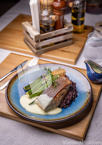 Image of Salmon steak with zucchini slices