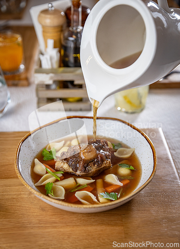 Image of Oxtail soup being served in a restaurant
