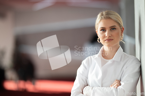 Image of Portrait of confident female doctor in clinic hallway