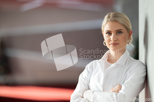 Image of Portrait of confident female doctor in clinic hallway