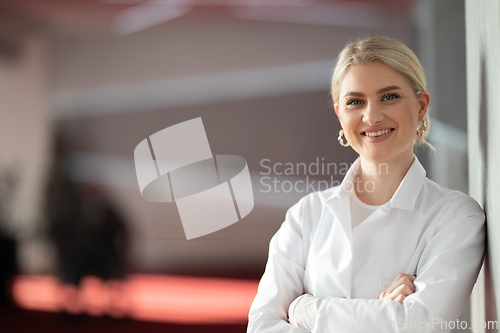 Image of Portrait of confident female doctor in clinic hallway