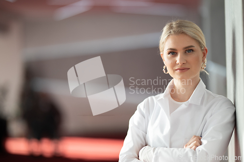 Image of Portrait of confident female doctor in clinic hallway