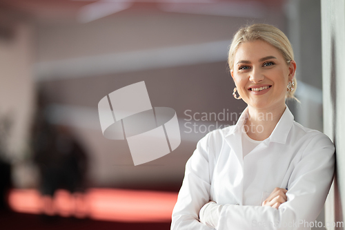 Image of Portrait of confident female doctor in clinic hallway