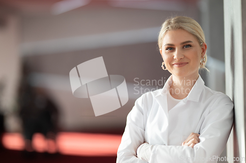 Image of Portrait of confident female doctor in clinic hallway