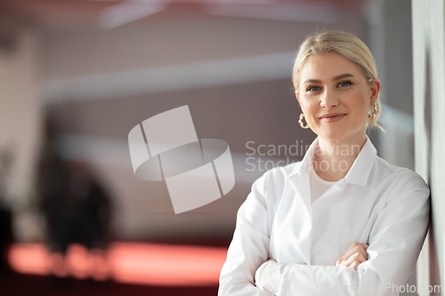 Image of Portrait of confident female doctor in clinic hallway
