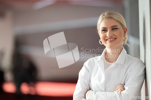 Image of Portrait of confident female doctor in clinic hallway