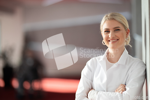 Image of Portrait of confident female doctor in clinic hallway