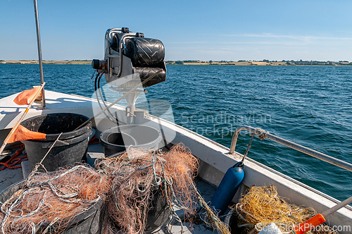 Image of Fishing boat with nets preparing for a calm day on the water at 