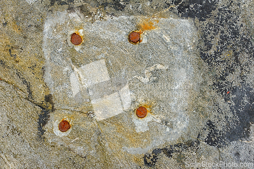 Image of Interesting close-up of a weathered surface with rusted bolts an