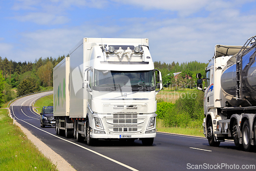 Image of Truck Traffic with White Volvo FH Transporter