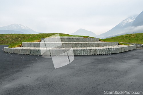 Image of Modern stone structure positioned in a tranquil landscape with r