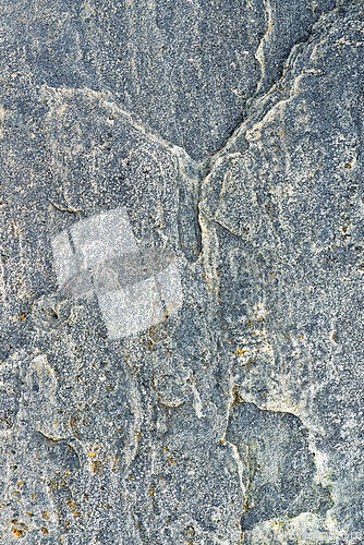 Image of Rough texture of cracked blue-gray stone with mineral deposits o
