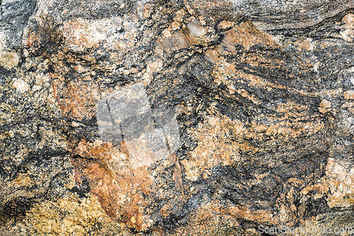 Image of Natural stone texture with swirling patterns and earthy colors i