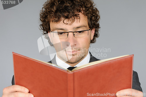 Image of Businessman reading book