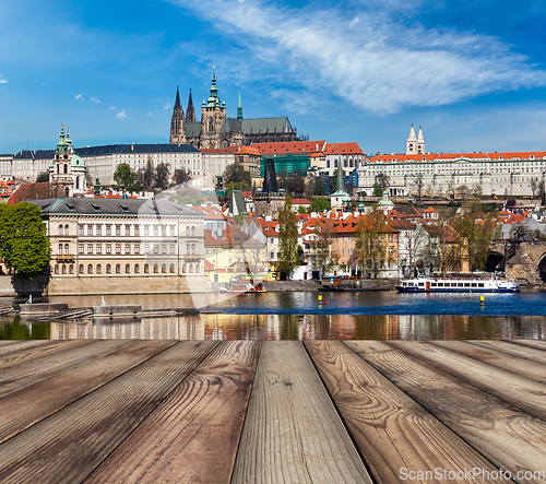 Image of Wooden planks vith view of Prague Charles bridge over Vltava riv