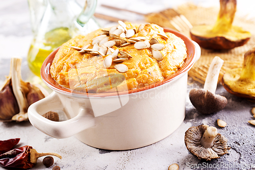 Image of Vegetarian autumn pumpkin cream soup with mushrooms and seeds