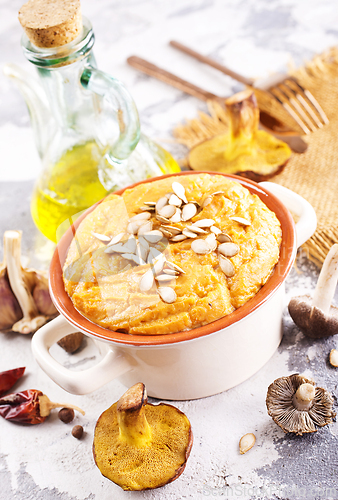 Image of Vegetarian autumn pumpkin cream soup with mushrooms and seeds