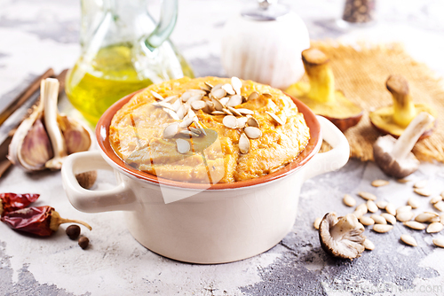 Image of Vegetarian autumn pumpkin cream soup with mushrooms and seeds