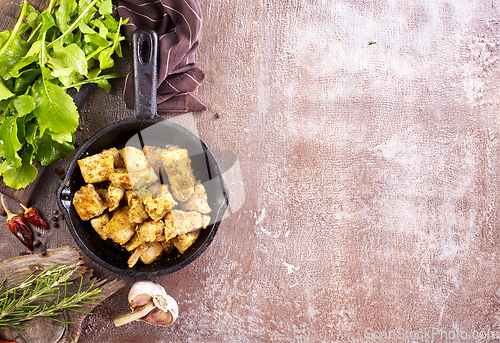 Image of fried meat with spice in pan