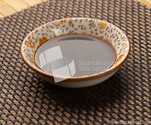 Image of Small bowl containing soy sauce
