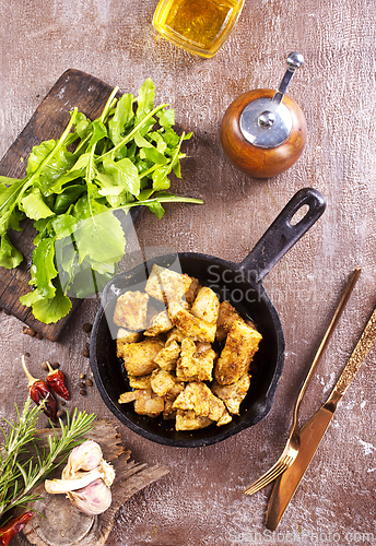 Image of fried meat with spice in pan