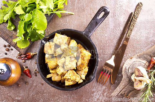 Image of fried meat with spice in pan