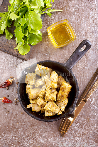 Image of fried meat with spice in pan