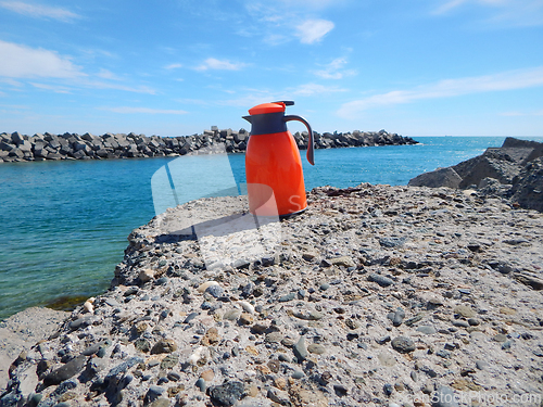 Image of Orange thermos jug.