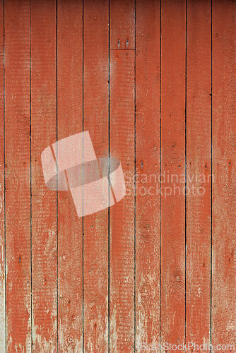 Image of Weathered red wooden wall shows texture and grain, hinting at hi