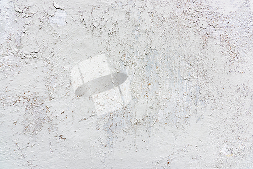 Image of Textured white wall with visible cracks and imperfections in nat
