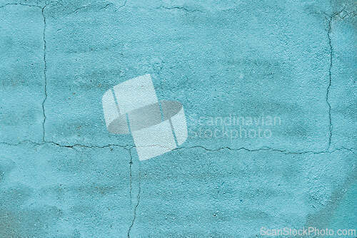 Image of Wall with a textured turquoise finish showing cracks and imperfe