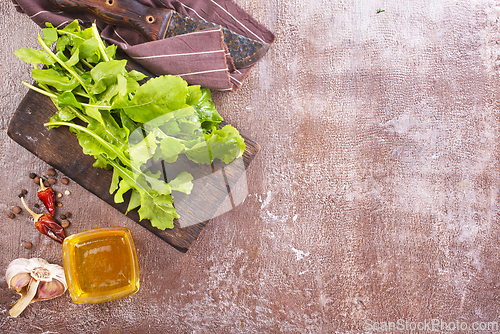 Image of Fresh arugula leaves, rucola on wooden board