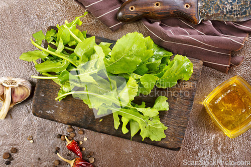 Image of Fresh arugula leaves, rucola on wooden board
