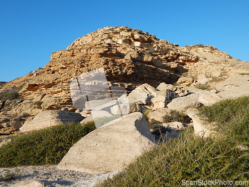 Image of Coastal cliff at sunset.