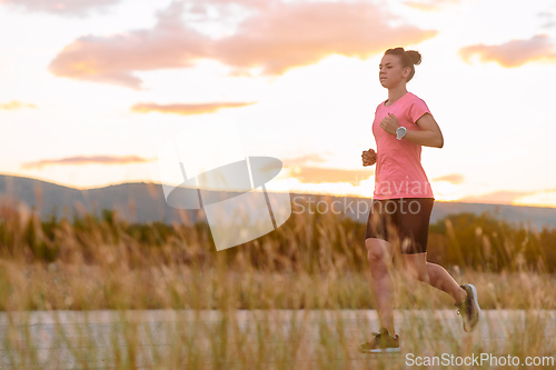 Image of Determined Athlete Running in the Sun amidst Beautiful Nature