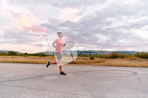Image of Determined Athlete Running in the Sun amidst Beautiful Nature