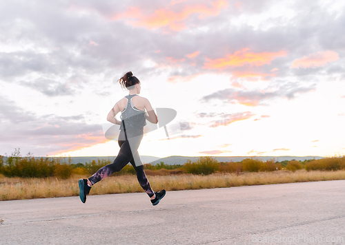 Image of Determined Athlete Running in the Sun amidst Beautiful Nature