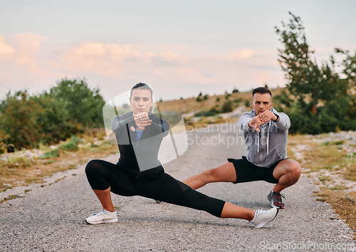 Image of Romantic Couple Stretching Together After an Intense Morning Run